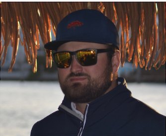 Captain Joey Nadotti under the thatched roof of the tiki boat