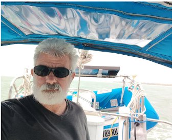 Captain Paul Stancati aboard a sailboat under a blue bimini