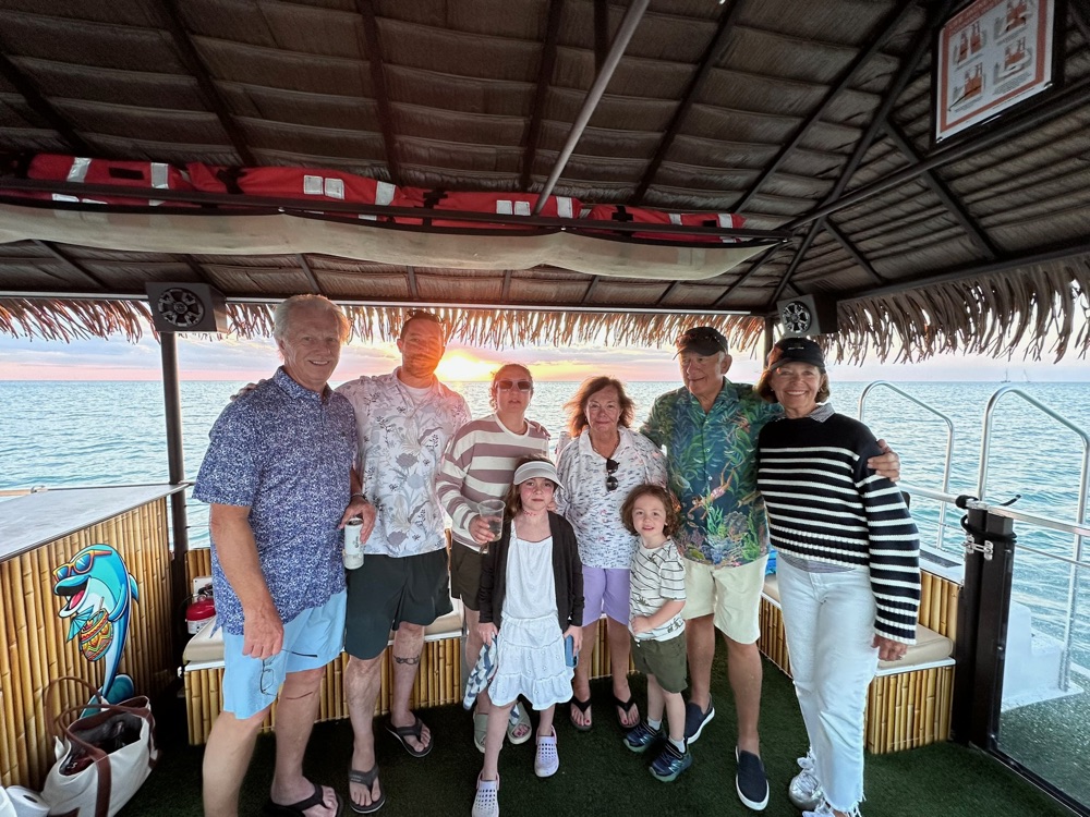 A family watching the Gulf sunset from a Sand Dollar boat near Naples, Florida