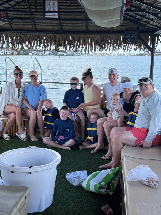 Toddlers safe and shaded aboard the family-friendly tiki boat during a private charter